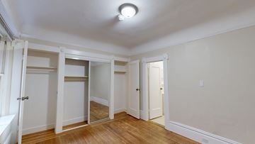 San Francisco apartment for rent - A room with a white ceiling and wooden floors with a mirror on the wall.