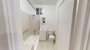 San Francisco apartment for rent - A white bathroom with a toilet, sink, and bathtub.