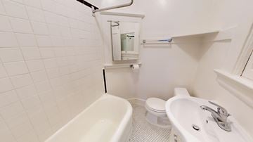 San Francisco apartment for rent - A white bathroom with a toilet, sink, and bathtub.