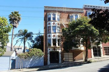 San Francisco apartment for rent - a red brick house with a black door and a tree