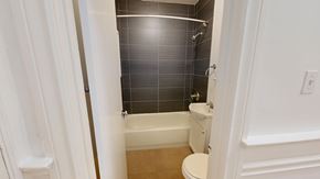 San Francisco apartment for rent - A white bathroom with a toilet, tub, and shower.