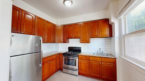 San Francisco apartment for rent - A kitchen with wooden cabinets and a stainless steel refrigerator.