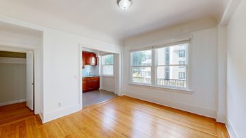 San Francisco apartment for rent - A room with wooden floors and white walls.