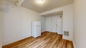 San Francisco apartment for rent - A white refrigerator in a room with wooden floors and white walls.
