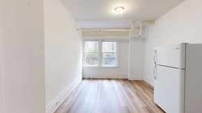 San Francisco apartment for rent - A white refrigerator is in a room with a window.
