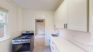 San Francisco apartment for rent - A kitchen with a stove, sink, and cabinets.