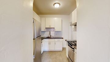 San Francisco apartment for rent - A kitchen with white cabinets and appliances.