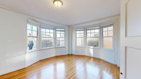 San Francisco apartment for rent - A room with wooden floors and white walls with windows.