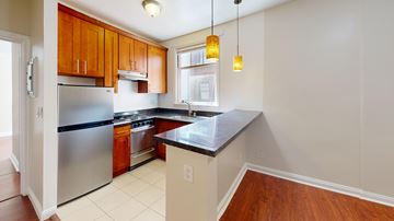 San Francisco apartment for rent - A kitchen with wooden cabinets and a stainless steel refrigerator.