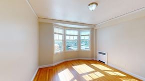 San Francisco apartment for rent - A sunny room with a view of the city through the windows.