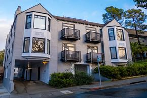 Berkeley apartment for rent - A building with a balcony and a tree in front of it.