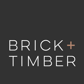 San Francisco apartment for rent - Logo of "Brick + Timber" a property management company in San Francisco, CA, displayed on a dark gray background. The "+" symbol is highlighted in a copper tone.