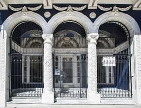 San Francisco apartment for rent - A black and white building with arched windows and a gate.