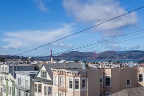 San Francisco apartment for rent - A cityscape with buildings and a bridge in the background.