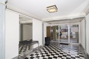 San Francisco apartment for rent - A black and white checkered floor in a room with a white ceiling and a black speaker.