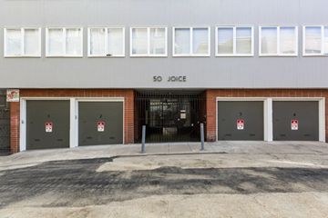 San Francisco apartment for rent - The image shows a building with the name "SO JOICE" on the facade and four doors with red and white signs in front of it.