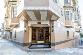 San Francisco apartment for rent - A building with a tan facade and a large wooden door.