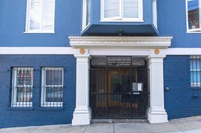San Francisco apartment for rent - A blue building with a black door and white columns.