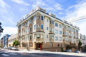 San Francisco apartment for rent - A large, multi-story building with a beige facade and blue trim.