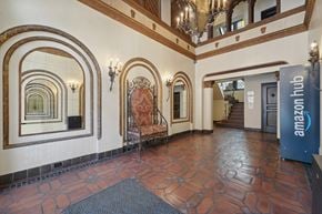 San Francisco apartment for rent - Ornate interior with tiled floor, decorative arches, mirrors, large chair, staircase, Amazon Hub