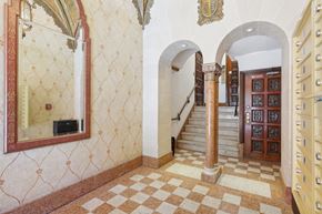 San Francisco apartment for rent - Hallway with a high ceiling and a large mirror with a wooden door