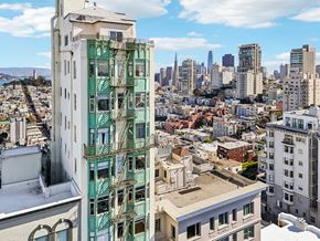 San Francisco apartment for rent - A cityscape with a green building in the foreground.