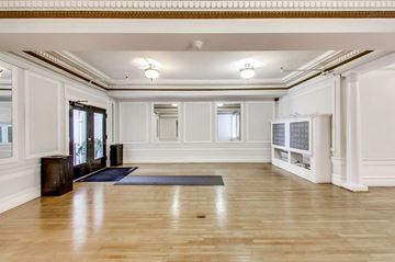 San Francisco apartment for rent - A spacious room with wooden floors and white walls.