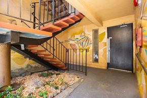 San Francisco apartment for rent - Hallway with a staircase and a small garden with rocks and plants