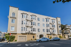 San Francisco apartment for rent - A beige building with a red stop sign in front of it.