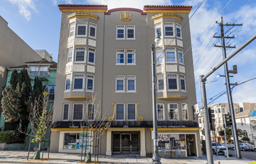 San Francisco apartment for rent - A street view of a building with a cafe on the ground floor.