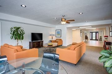 Indianapolis apartment for rent - A living room with orange couches and a television.