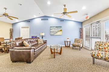 Indianapolis apartment for rent - A living room with a brown couch and a ceiling fan.