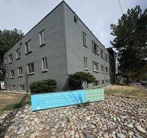 Littleton apartment for rent - A grey building with a sign in front that says Powers Circle Apartments.