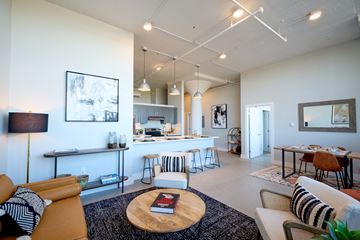 Biddeford apartment for rent - A living room with a white couch and a coffee table with a book on it.