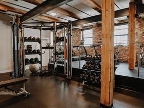 Biddeford apartment for rent - a gym with weights and a brick wall and a window