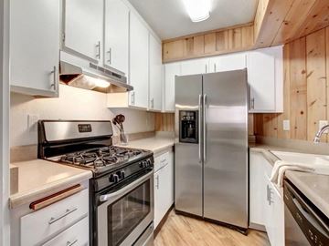 Van Nuys apartment for rent - a kitchen with stainless steel appliances and white cabinets