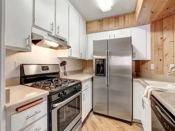 Van Nuys apartment for rent - a kitchen with stainless steel appliances and white cabinets