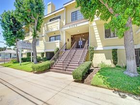 Van Nuys apartment for rent - the front of an apartment building with stairs and trees