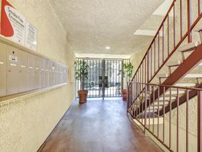 Van Nuys apartment for rent - a long hallway with stairs and a door to a balcony