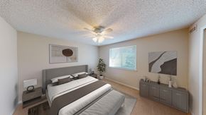 Orchard Park apartment for rent - a bedroom with a bed and a ceiling fan
