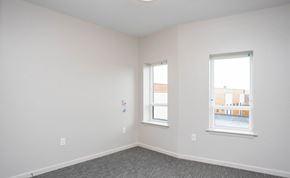 Irondequoit apartment for rent - a bedroom with two windows and white walls