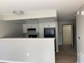 Fairport apartment for rent - a kitchen with white cabinets and a counter top