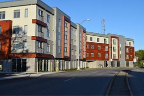Rochester apartment for rent - A row of modern apartment buildings are lined up along a street.
