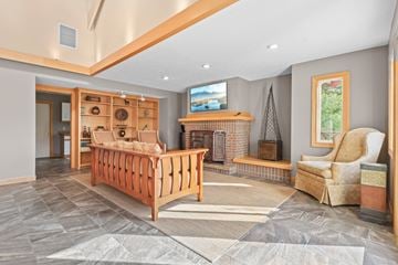 Stow apartment for rent - A living room with a wooden sofa and a fireplace.