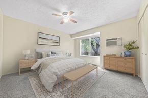 Kent apartment for rent - A bedroom with a bed, nightstand, and a ceiling fan.
