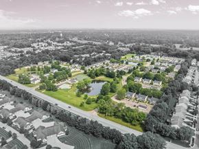 Cuyahoga Falls townhouse for rent - A bird's eye view of a residential area with houses, a swimming pool, and a road.