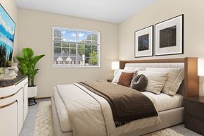 Cuyahoga Falls townhouse for rent - A bedroom with a large bed and a potted plant.