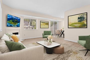 Cuyahoga Falls townhouse for rent - A living room with a green couch and a painting on the wall.