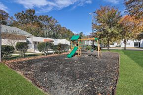 Savannah apartment for rent - A playground with a green slide and a sandbox.