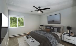 Denver apartment for rent - the master bedroom has a large bed and a ceiling fan